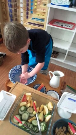 Lyonsgate Montessori School Casa student at the handwashing station activity (which is separate from the sink handwashing).