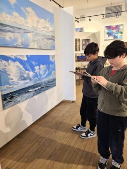 Lyonsgate Montessori School Elementary students sketching their favourite pieces during their community outing to Crown and Press Gallery and Cafe.