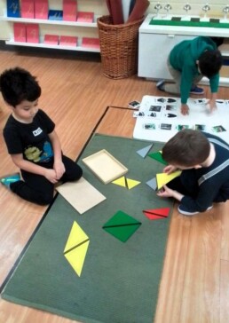 Lyonsgate Montessori School Casa students working together with the Montessori Constructive Triangles material.