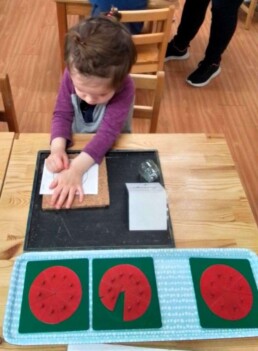 Lyonsgate Montessori School Casa student developing fine motor control and concentration skills by 