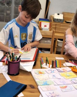 Lyonsgate Montessori School Elementary student creating cards for a French game.