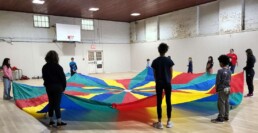Lyonsgate Montessori School Elementary students enjoying some classic parachute fun during phys. ed.