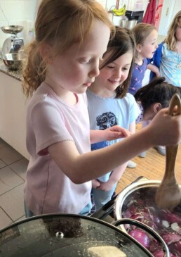 Lyonsgate Montessori School Elementary students stirring a botanical dye bath.