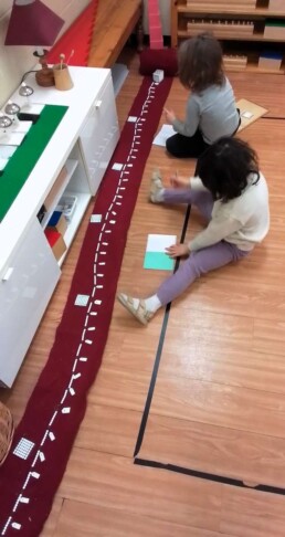 Lyonsgate Montessori School Casa students learning their 7-times-table with the Montessori Bead Chain material.