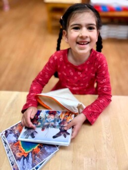 Lyonsgate Montessori School Casa student preparing to work with a set of culture cards.