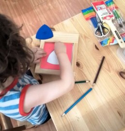 Lyonsgate Montessori School Casa student working with the Montessori Metal Insets material.