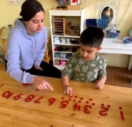 Lyonsgate Montessori School Casa student receiving a presentation of the Montessori Numerals and Counters material.