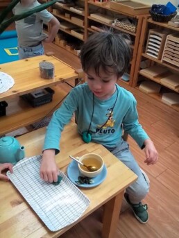 Lyonsgate Montessori School Casa student successfully working through the steps to make a cup of tea (and to clean up the inevitable spills).