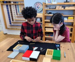 Lyonsgate Montessori School Elementary students learning to add positive and negative integers.