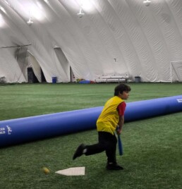 Lyonsgate Montessori School Elementary student taking batting practice during phys. ed. at Soccer World.
