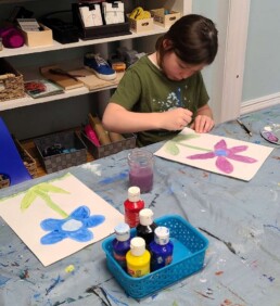 Lyonsgate Montessori School Elementary student working on her floral painting.