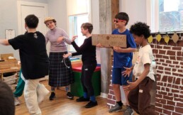 Lyonsgate Montessori School Elementary students building French language skills by performing a play called 
