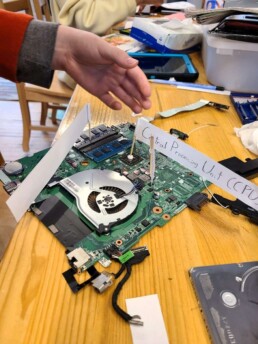 Lyonsgate Montessori School Elementary student labelling the parts of a laptop.