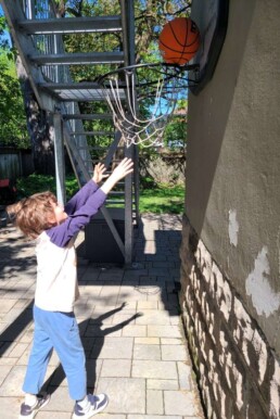 Lyonsgate Montessori School Elementary student enjoying some of the recent beautiful weather with a little basketball.