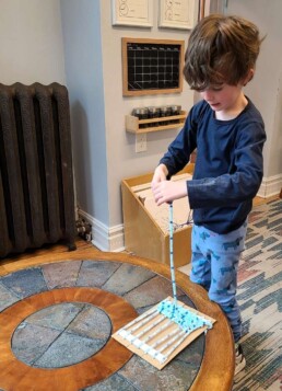 Lyonsgate Montessori School Elementary student working on a weaving project.