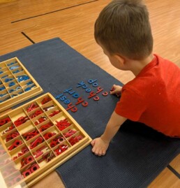Lyonsgate Montessori School Casa student the Montessori Print (versus cursive) Moveable Alphabet material to learn about the digraph 