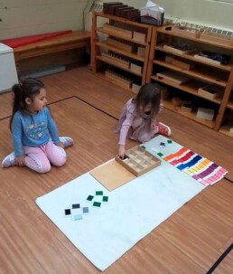 Lyonsgate Montessori School Casa students working together to complete the Montessori Colour Box 3 material to help develop visual discrimination.