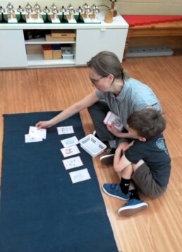 Lyonsgate Montessori School Casa student building his French vocabulary with his classroom's French language assistant.