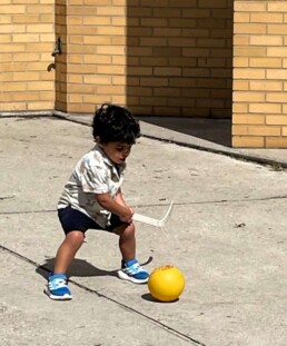 Lyonsgate Montessori School Toddler student bringing playoff hockey to the playground.