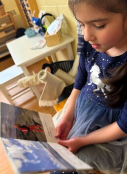 Lyonsgate Montessori School Casa student enjoying some quiet reading.