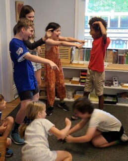 Lyonsgate Montessori School Elementary students creating a drama tableau.
