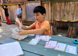Lyonsgate Montessori School Elementary student working to master subtraction facts in the outdoor classroom.