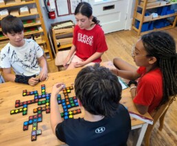 Lyonsgate Montessori School Elementary students undertaking mathematical thinking with Qwirkle.