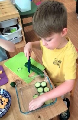 Lyonsgate Montessori School Casa student helping to prepare the daily snack for his class.