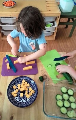 Lyonsgate Montessori School Casa student helping to prepare the daily snack for his class.