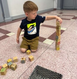 Lyonsgate Montessori School Toddler student demonstrating the results of a school year's worth developing motor control and concentration skills.